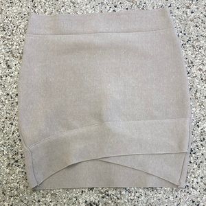 Cute tan mini skirt in size small. Brand is Poof Couture.